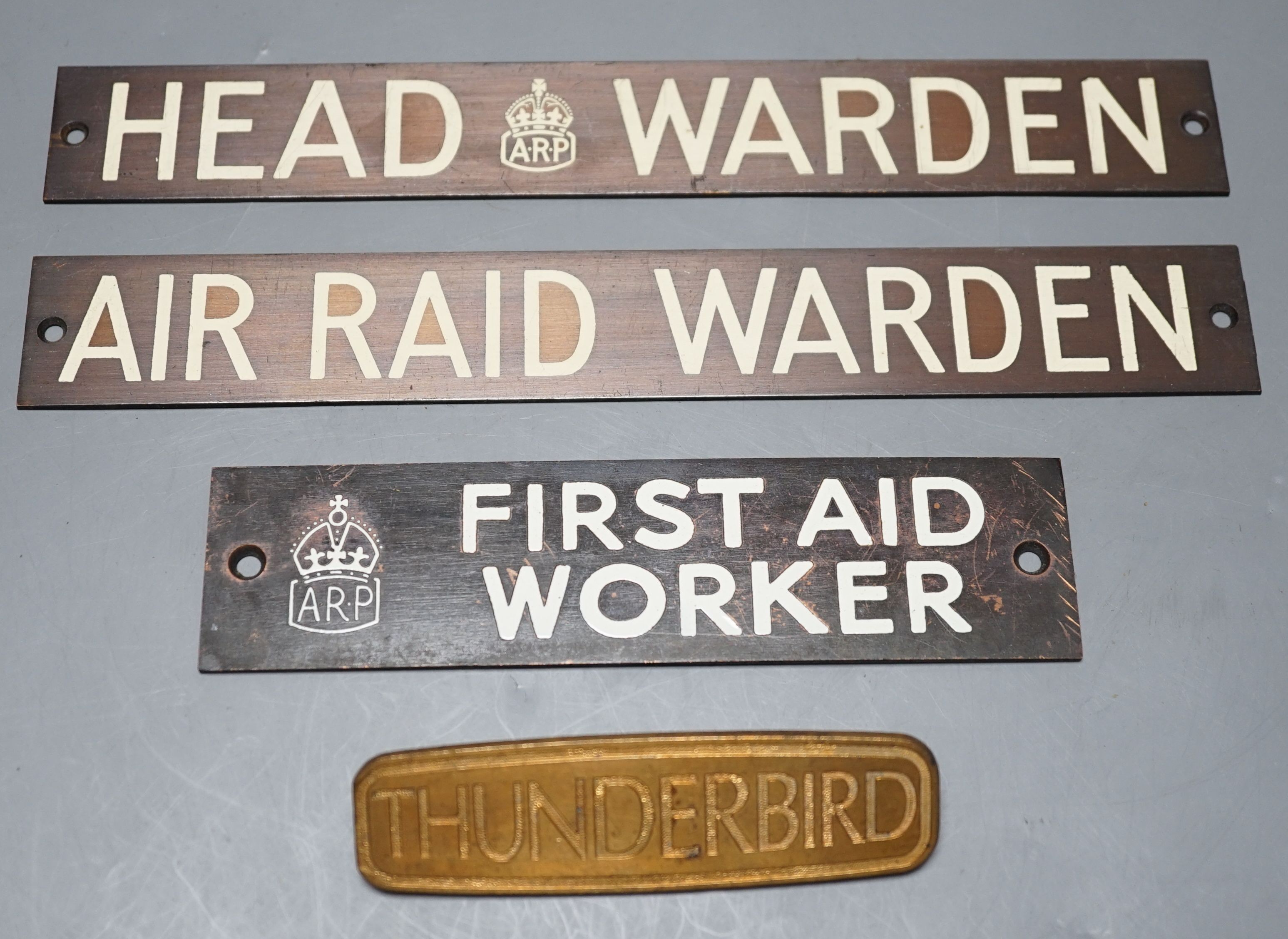 Three Air Raid Precautions signs together with a ‘Thunderbird’ sign. (4) largest 3 x 23cm